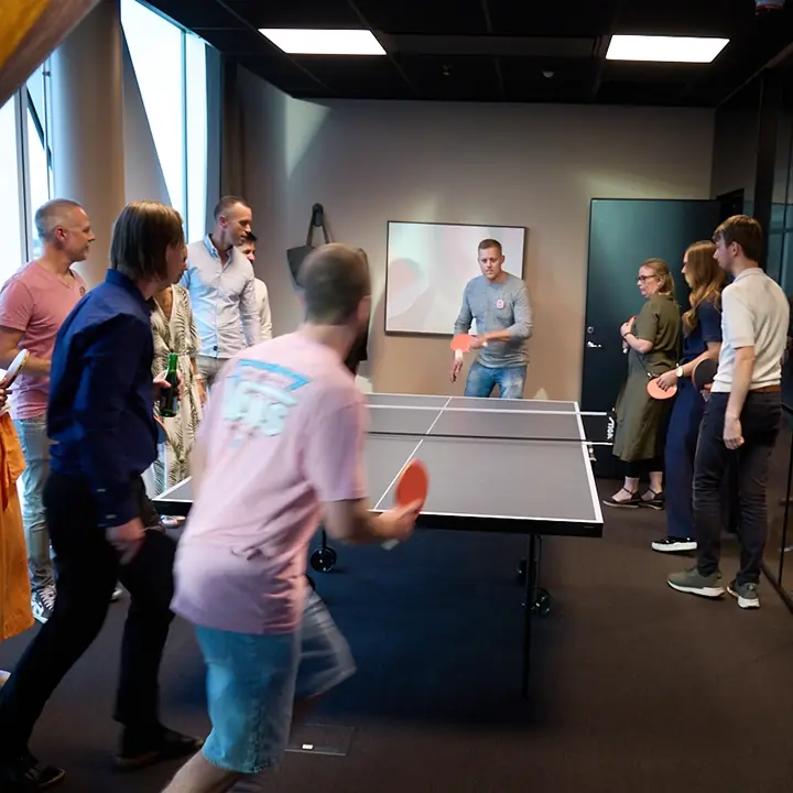 Medarbetare spelar pingis på kontoret