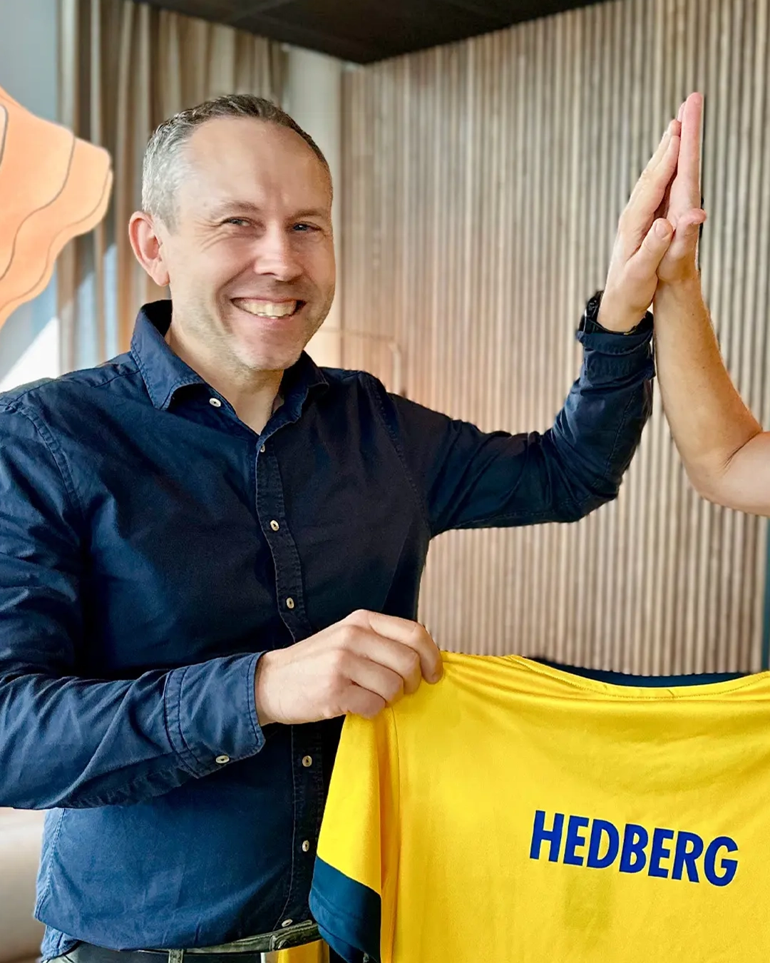 Martin Hedberg, CTO på WeAudit, klappar händerna mot en kollega